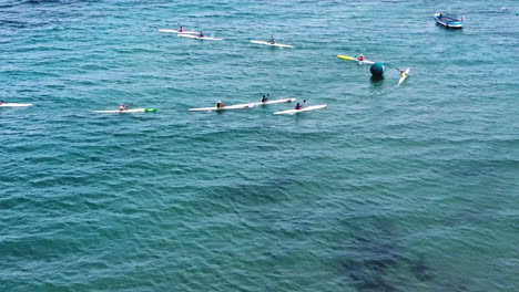 Surf-ski-competitors-rotating-on-a-sea-buoy-in-a-competition