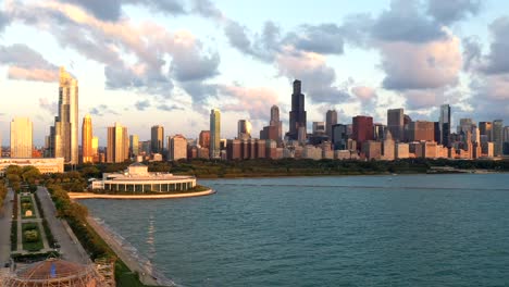 Wide-drone-hyperlapse-of-the-chicago-skyline-during-golden-hour-with-clouds-and-lake-michigan