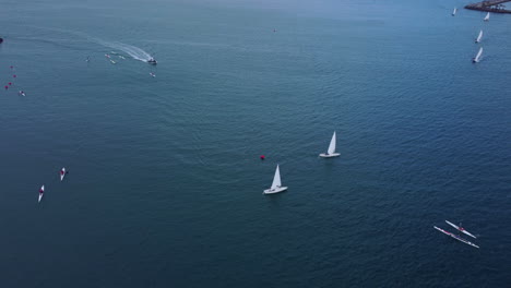 Sailing-boats-and-surf-ski-competitors-in-the-crystal-clear-water-of-canary-waters-in-spain