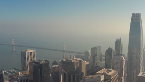 Rising-aerial-shot-over-San-Francisco-skyscrapers-looking-out-towards-the-bay