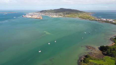 Coastal-town-and-white-boats-in-Bluff,-New-Zealand,-aerial-drone-view