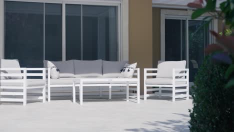 Garden-furniture-on-a-terrace-with-its-sofa-and-wooden-benches