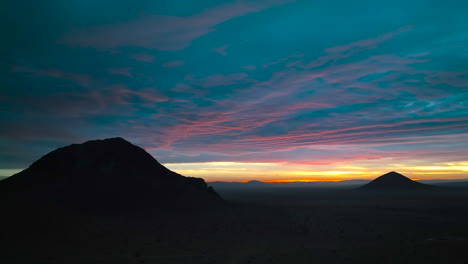 Colorful-sunrise-over-a-butte-in-the-Mojave-Desert---aerial