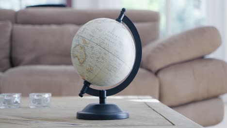 Rotation-around-a-terrestrial-globe-placed-on-a-living-room-table
