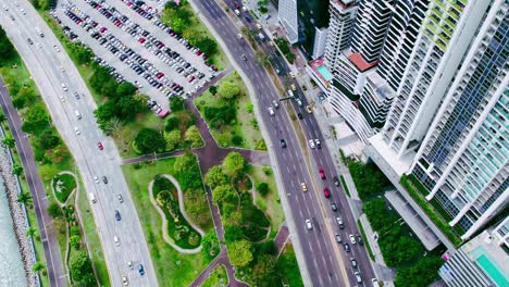 High-angle-drone-view-over-Cinta-Costera,-busy-traffic-on-Beltway,-Panama-City
