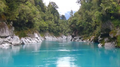 Water-level-view-of-spectacular-turquoise-colored-river,-granite-rocks-and-podocarp-forest---Hokitika-River-Gorge-Walk,-West-Coast