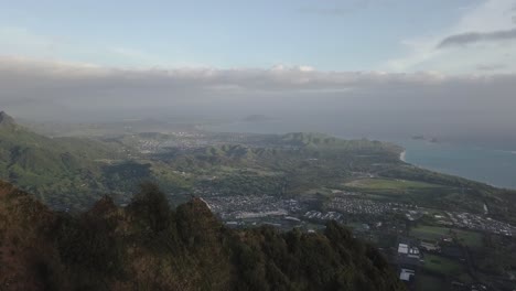 Aerial-push-over-mountain-tops-in-Hawaii-Kai-Honolulu's-eastern-side-in-the-morning-light-revealing-the-city-below