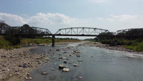 View-of-bridge-over-river-with-rocks