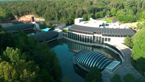 low-drone-shot-of-crystal-bridges-over-a-small-lake