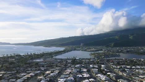 Slow-moving-aerial-dolly-of-Hawaii-Kai-city-in-Honolulu-Hawaii-with-bright-skies-and-fluffy-white-clouds