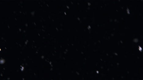 rapidly-falling-snowflakes-flurrying-around-in-a-black-winter-night