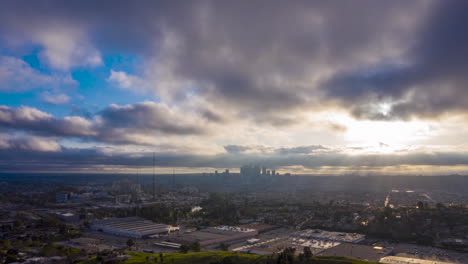 Drohnen-Hyperlapse-Während-Des-Sonnenuntergangs-über-Einem-Vorort-Von-Los-Angeles-Mit-Der-Skyline-Silhouette-Der-Innenstadt-In-Der-Ferne