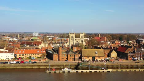 Aerial-view-of-Kings-Lynn-Minster-and-riverfront,-River-Great-Ouse,-Kings-Lynn,-Norfolk,-UK