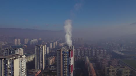 Aerial-view-of-chimney-with-heavy-smoke-in-polluted-City-on-sunny-day