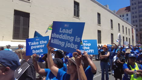 A-group-of-Democratic-Alliance-supporters-hold-up-placards-and-flags-protesting-load-shedding