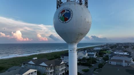 Drone-shot-of-water-tower-at-a-beach-town