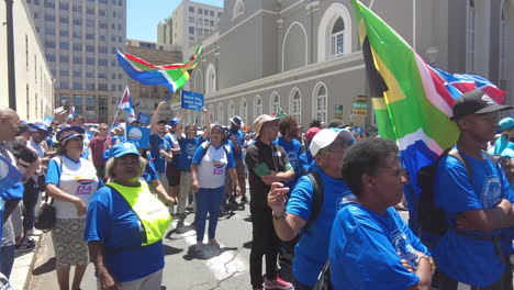 Protestors-sing-and-dance-while-waving-flags-at-a-protest-against-Eskom's-load-shedding-and-rolling-blackouts