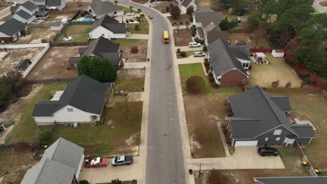 Drone-shot-of-a-school-bus-in-neighborhood