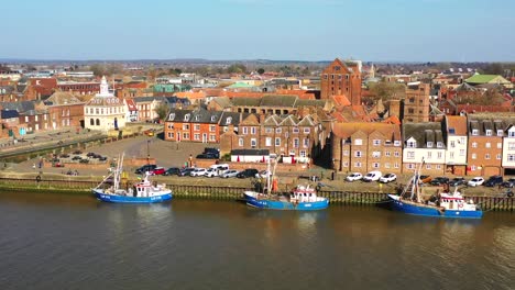 Aerial-view-of-Kings-Lynn-riverfront,-trawlers,-Customs-House-and-the-River-Great-Ouse,-Kings-Lynn,-Norfolk,-UK