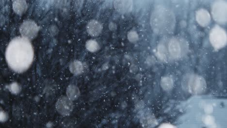 close-up-video-of-snow-falling-in-slow-motion,-with-more-snow-falling-as-time-goes-on