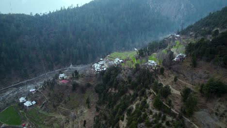 Valley-view-of-Kashmir,-close-shot-of-houses-and-the-stream-with-trees-and-fields-in-Kashmir-neelum-valley-ajk