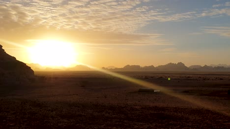 Golden-sunlight-at-sunset-over-wilderness-of-Arabian-desert-and-rugged-mountainous-landscape-in-Jordan,-Middle-East
