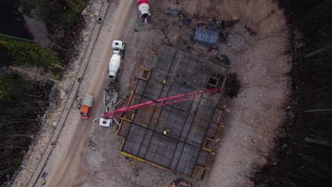 Bird-view-of-a-construction-site-with-workers-and-truck-passing-by