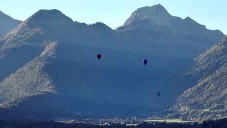 Three-hot-air-balloons-taking-off-in-a-summer-morning-in-the-French-Alps