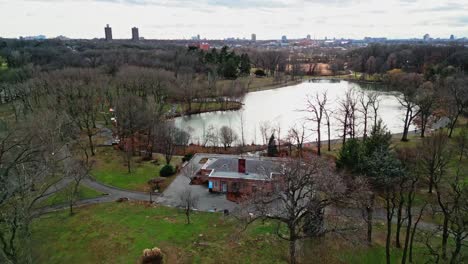 Aerial-flyover-park-with-Kissena-Lake-in-Queens-District-of-New-York-during-sunny-day