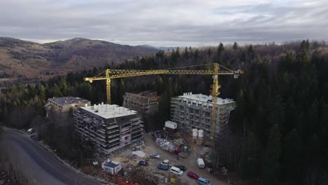 Aerial-shot-of-a-construction-site-on-a-mountain-covered-with-forest