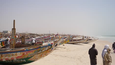 People-and-Fishing-Boat-at-Oceanside-of-Mauritania,-Everyday-Life-in-Western-Sahara-Country