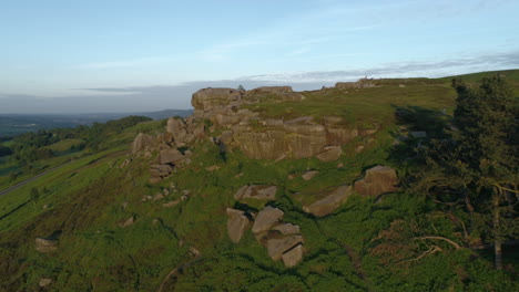 Forward-Drone-Shot-Flying-up-towards-Cow-and-Calf-Rock-Formation-on-Ilkley-Moor-West-Yorkshire-UK