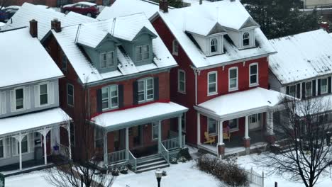 Long-aerial-zoom-of-cute-snow-covered-town-houses