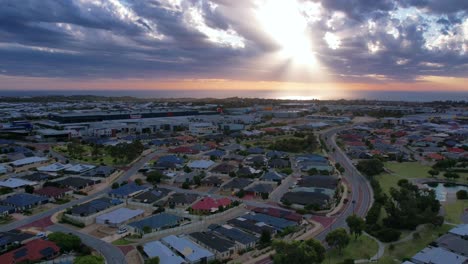 Aerial-hyper-lapse-of-the-changing-light-while-flying-over-the-Clarkson-suburb-towards-Mindarie-as-the-clouds-create-light-rays-over-the-ocean