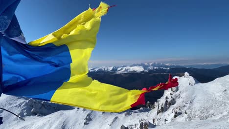 Flag-in-the-wind-on-a-sunny-winter-day-in-Ciucas-mountains-from-Romania