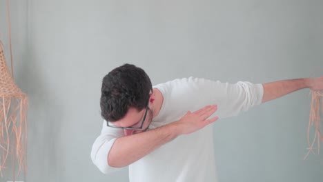 young-man-doing-dabbing,-young-teen-trend-move-by-hipster-with-beard-and-glasses