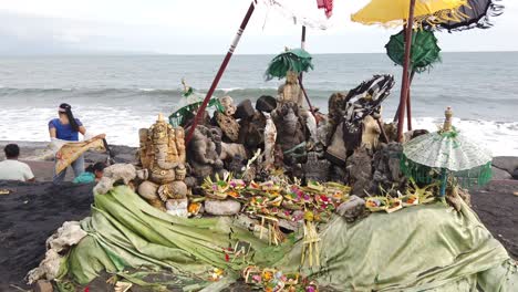 Purnama-Beach-in-Bali,-Indonesia,-Temple-in-the-Sand,-Ganesha,-Umbrellas-and-Colourful-Flower-Offerings-at-Hindu-Sacred-Natural-Space,-Balinese-Hinduism