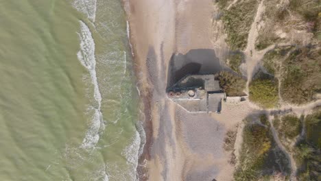 Top-view-of-an-abandoned-WW2-arrowhead-shaped-bunker-on-the-Baltic-Sea-beach