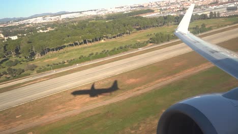 Plane-take-off-shadow-on-the-ground-as-it-leaves-the-surface