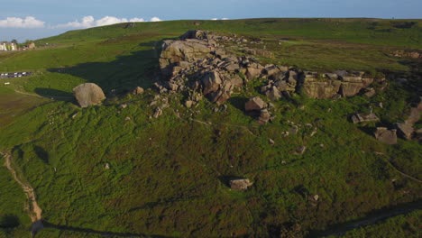 Pullback-Establishing-Drone-Shot-of-Cow-and-Calf-Rocks-Rock-Formation-on-Ilkley-Moor-at-Golden-Hour-West-Yorkshire-UK