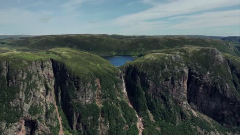Gros-Morne-National-Park,-Newfoundland---Push-In-Drone-Clip-of-waterfall-on-mountain