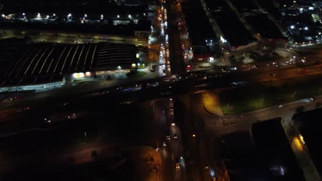 Drone-shot-by-night,-flying-above-busy-highways-and-crossroads-in-Bogota,-the-capital-of-Colombia