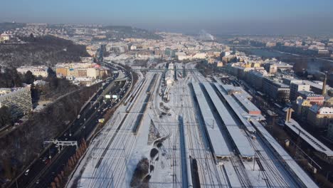 Smichov-railway-station-in-Prague,-Czech-Republic,-aerial-drone-view,-winter-sunny-day,-fly-back