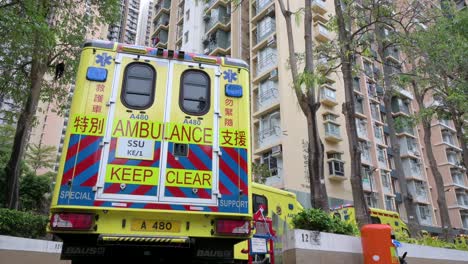 A-row-of-ambulances-is-seen-parked-outside-a-building-placed-under-Covid-19-Coronavirus-lockdown-at-a-public-housing-complex-after-a-large-number-of-residents-tested-positive