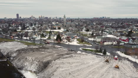 Bulldozers-Plowing-Snow-At-The-Snow-Dump-After-Winter-Storm-In-Buffalo,-New-York,-USA