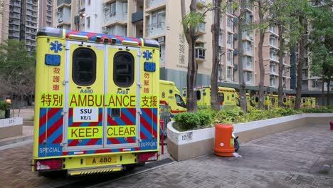 A-row-of-ambulances-are-seen-parked-outside-a-building-placed-under-Covid-19-Coronavirus-lockdown-at-a-public-housing-complex-after-a-large-number-of-residents-tested-positive