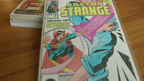 Close-Up-Tilt-Down-of-a-Doctor-Strange-Comic-Book-on-a-Table