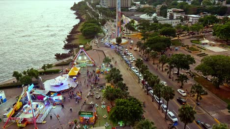 Amusement-park-along-Malecon-with-obelisk-in-Juan-Baron-square,-Santo-Domingo-in-Dominican-Republic