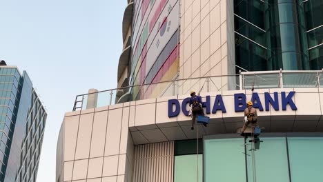 Work-at-height-for-cleaning-building-with-luxury-material-glassy-metal-composite-or-official-government-trading-building-and-tower-center-in-Doha-Qatar