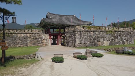 Entryway-to-historic-stone-walled-Naganeupseong-Folk-Village,-left-to-right-pan
